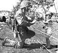 A US Marine gives candy to Japanese child at Tinian internment camp