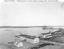 USNA waterfront in the late 1860s with the barrack/school ships USS Constitution and Santee tied up in the background. Other ships not identified.