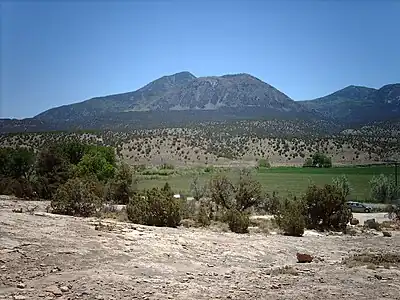 Mountain range with one prominent peak in the center left of the photograph.