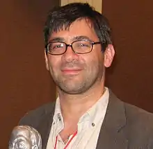 Head shot of a man at a microphone