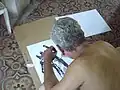 Victor Moreno while he is drawing the jirafe Guckindieluft