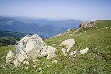 View of mountains with boulder in the foreground