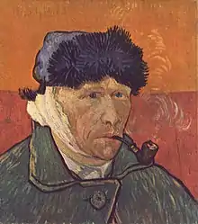 Portrait of a clean shaven man wearing a furry winter hat and smoking a pipe, facing to the right with a bandaged right ear