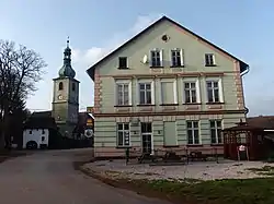 Inn in the centre of Vlčice and Church of Saint Adalbert