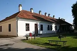 House in front of which is monument to Milovan Glišić