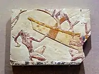 Egyptian boatbuilding relief, featuring a workman using an adze