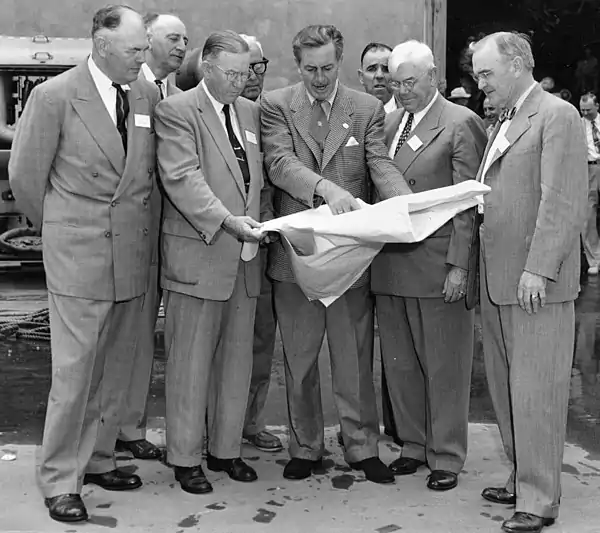 Several men looking at plans together