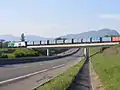 crosses the RD884 near Farges (the daily municipal waste train is seen, heading for Bellegarde)