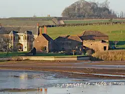 Stone buildings with water in front.