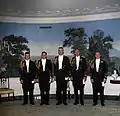 White House social aides pictured during the presidency of John Kennedy in the Diplomatic Reception Room