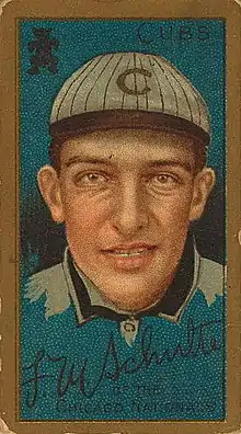 A baseball-card image of a smiling man wearing a crownless white pinstriped baseball cap