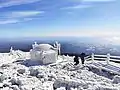 Hallasan and its summit weather station covered with windswept ice on a cold November afternoon, overlooking the Yellow Sea