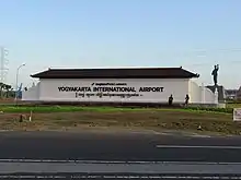 The Yogyakarta International Airport's nameplate with a cungkup above it