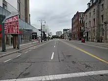 Looking west from the middle of York Boulevard from downtown Hamilton. To the left is a public library and the First Ontario Centre, and further down the street and on the right is a historic train station building.