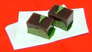 Yōkan is a thick, jellied dessert made of red bean paste, agar, and sugar. It is usually sold in a block form, and eaten in slices.