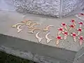 Muslim crescents and remembrance crosses left as tokens of remembrance at a war memorial