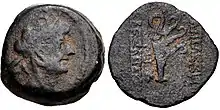  Coin of Alexander II. On the obverse, a bust of the king wearing a headdress in the shape of an elephant head. On the reverse, a ship aphlaston is shown