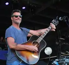 Country music singer Deryl Dodd strumming a guitar