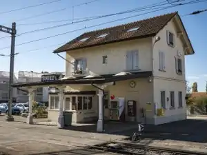 Two-story building with gabled roof and awning